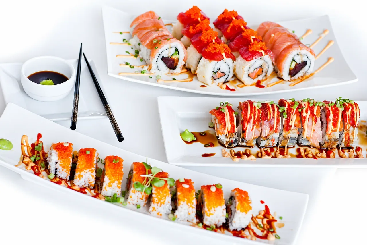 Three plates of sushi rolls